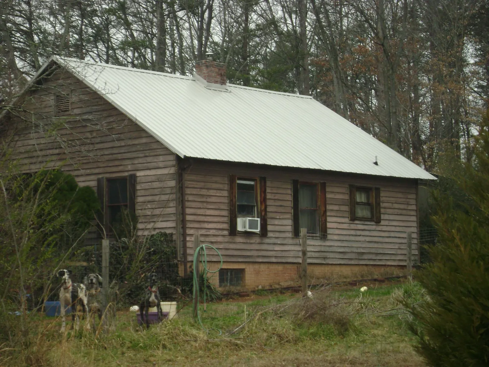 White metal roof on an old wood sided farmhouse, from a Metal Roof Installation job in Vanceboro